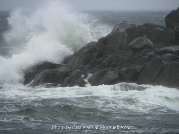 Stormy waves, crashing on rocks. 